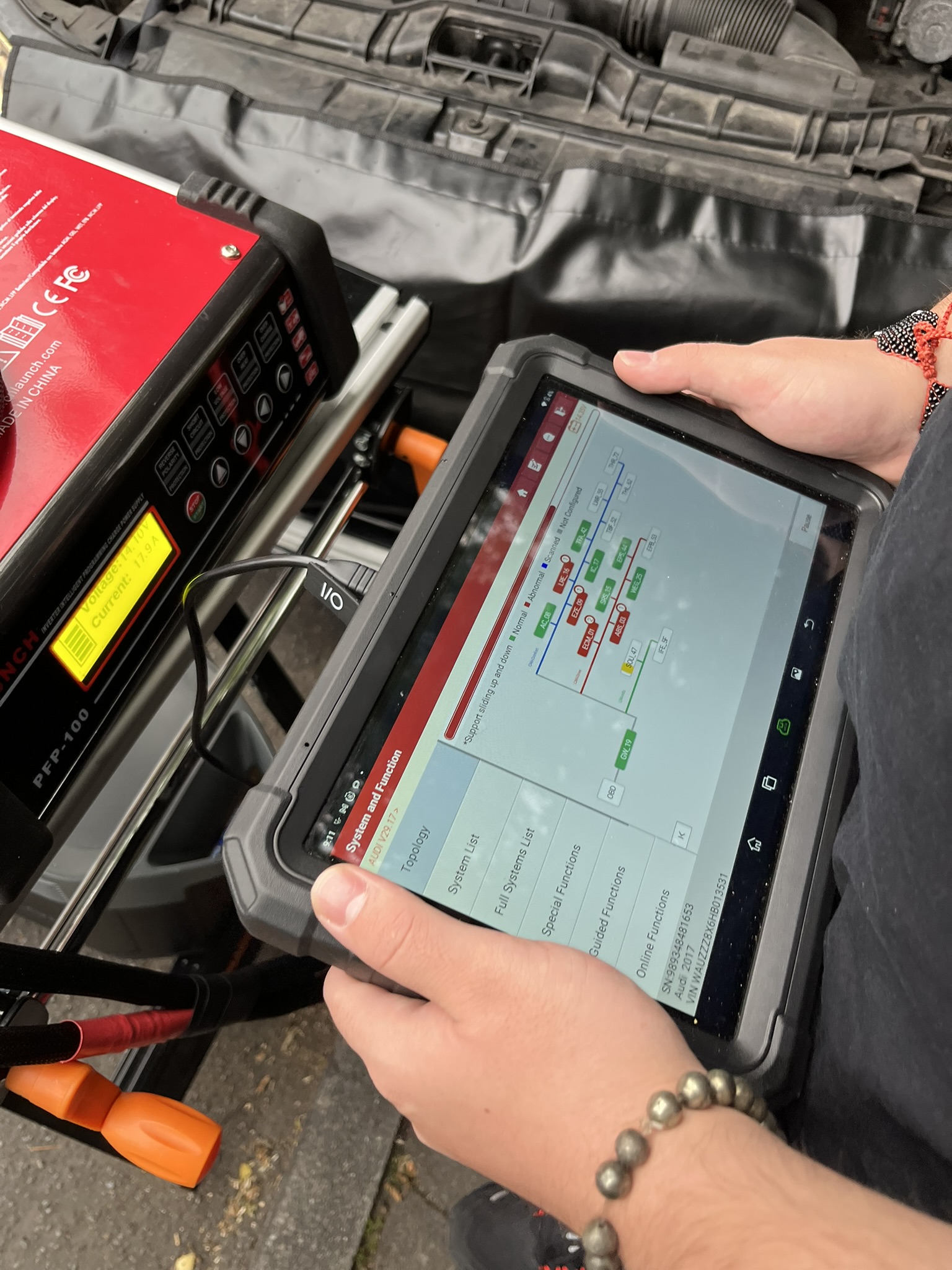 Diagnostic tablet in use during a vehicle job