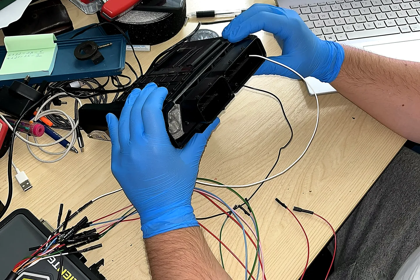 ECU preparation with protective gloves and professional programming equipment