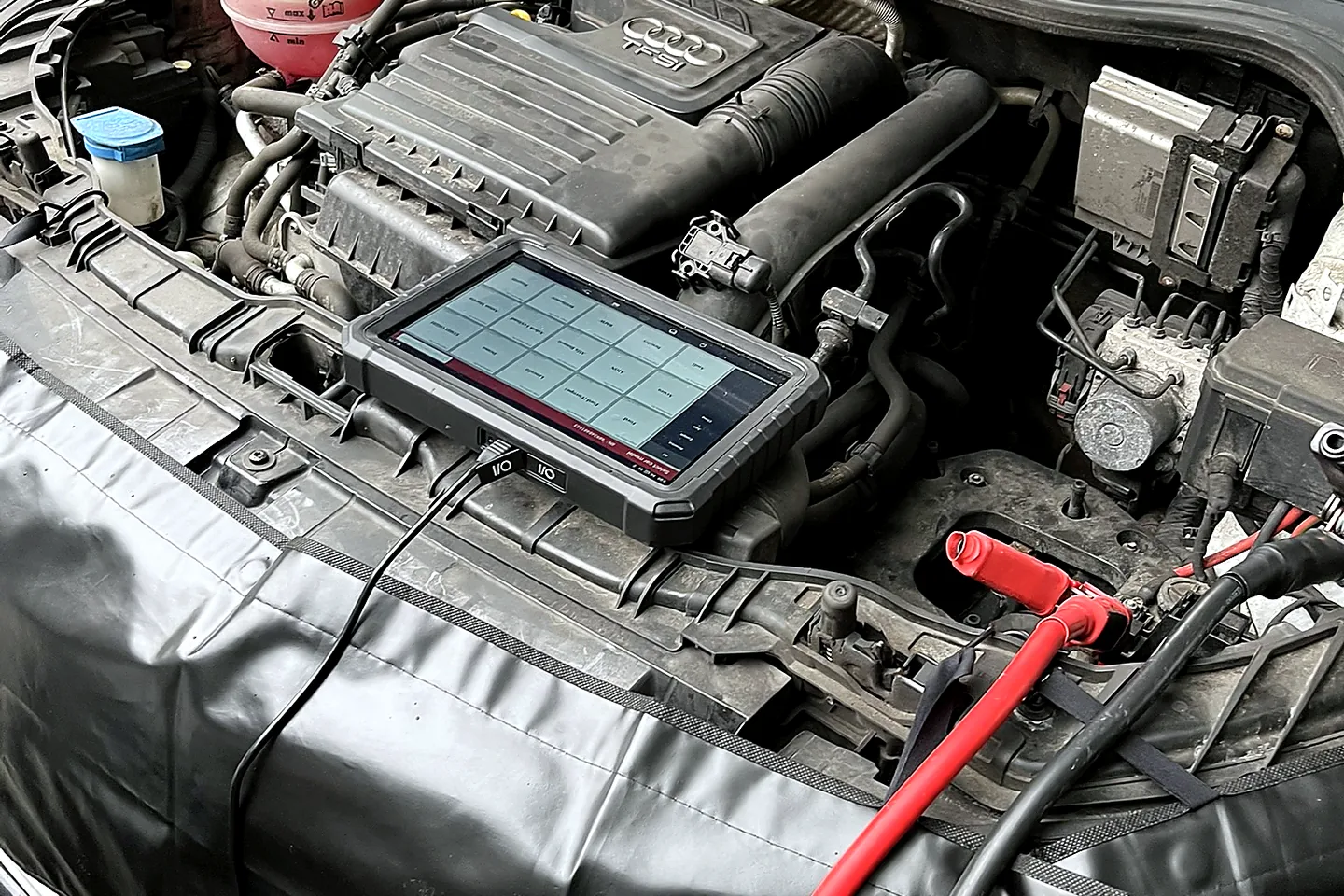 Professional diagnostic tablet positioned safely at the vehicle